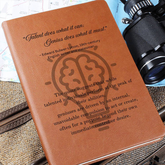 Close up image. Notebook journal with cover quote: Edward Bulwer-Lytton's "Talent does what it can; Genius does what it must." black text layered on a lightbulb on the brown vegan leather cover.