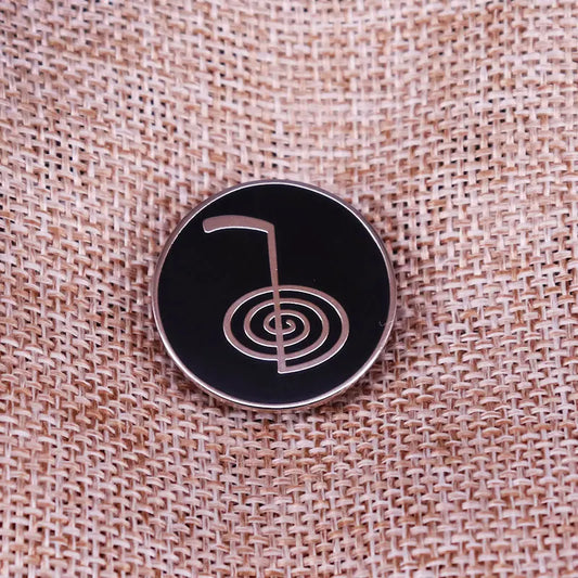Cho Ku Rei, Reiki Power Symbol Pin on fabric background