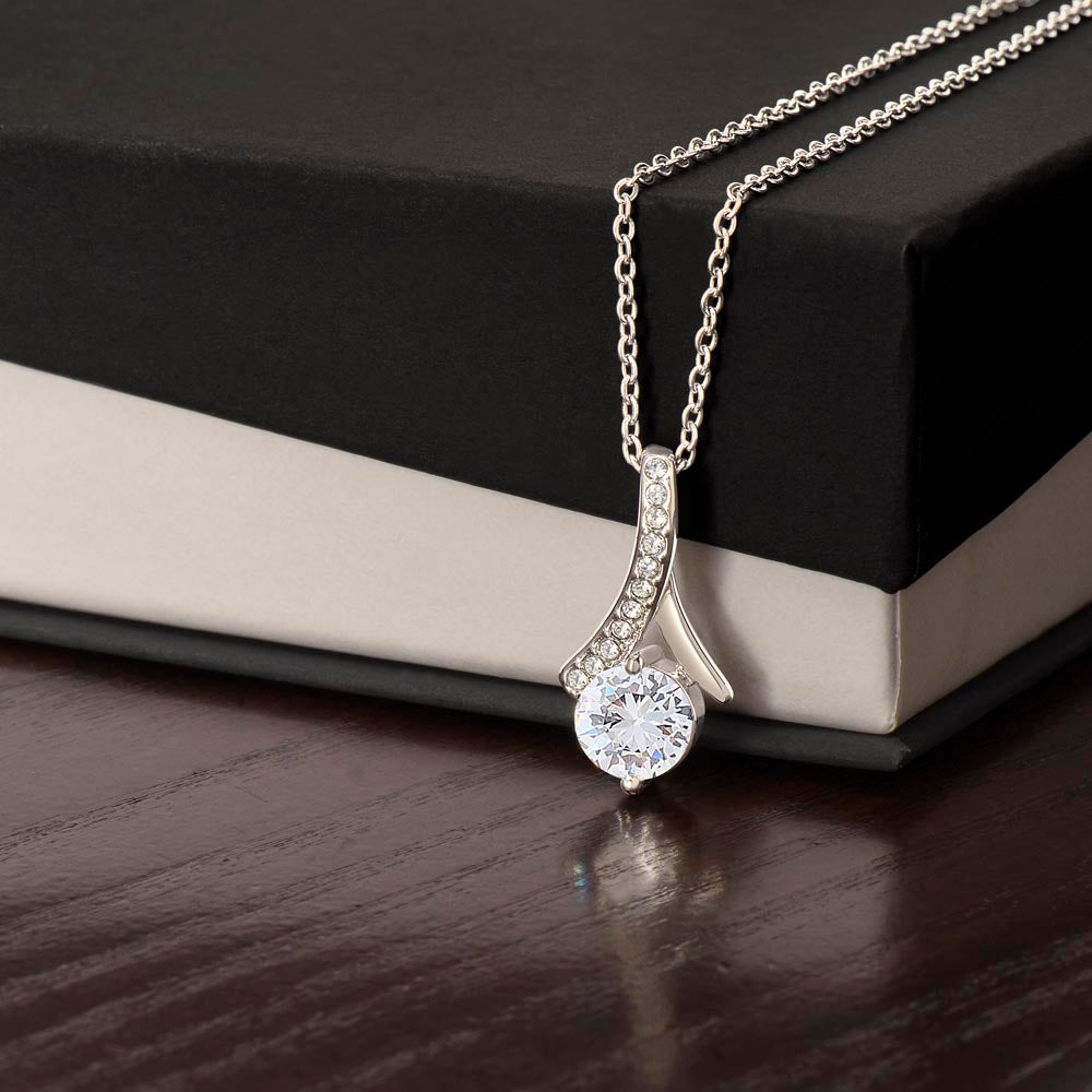 Alluring Beauty Petite Ribbon Shaped Pendant in 14k White Gold Finish or 18k Yellow Gold Finish over Stainless Steel with a 7mm Cubic Zirconia (No Message Card)