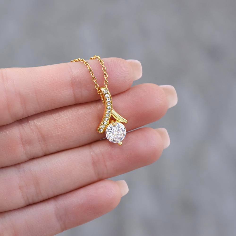 Alluring Beauty Petite Ribbon Shaped Pendant in 14k White Gold Finish or 18k Yellow Gold Finish over Stainless Steel with a 7mm Cubic Zirconia (No Message Card)