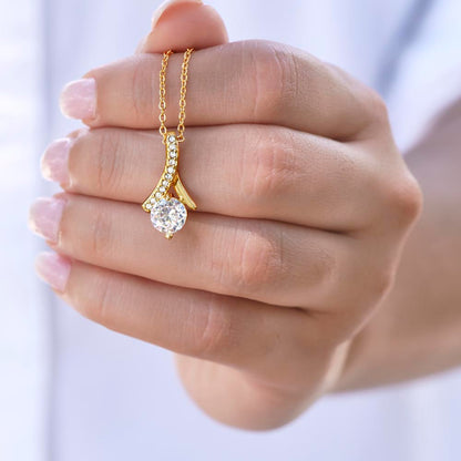 Alluring Beauty Petite Ribbon Shaped Pendant in 14k White Gold Finish or 18k Yellow Gold Finish over Stainless Steel with a 7mm Cubic Zirconia (No Message Card)