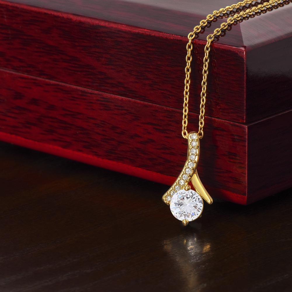 Alluring Beauty Petite Ribbon Shaped Pendant in 14k White Gold Finish or 18k Yellow Gold Finish over Stainless Steel with a 7mm Cubic Zirconia (No Message Card)