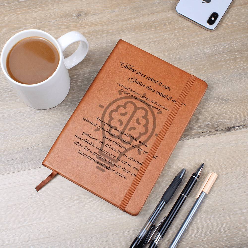 Notebook journal with cover quote: Edward Bulwer-Lytton's "Talent does what it can; Genius does what it must." black text layered on a lightbulb on the brown vegan leather cover. Table with coffee mug and pens image.